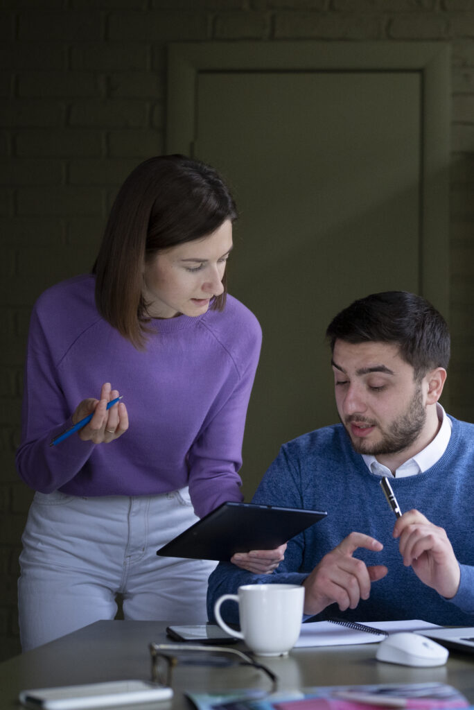 medium shot people working together office 1