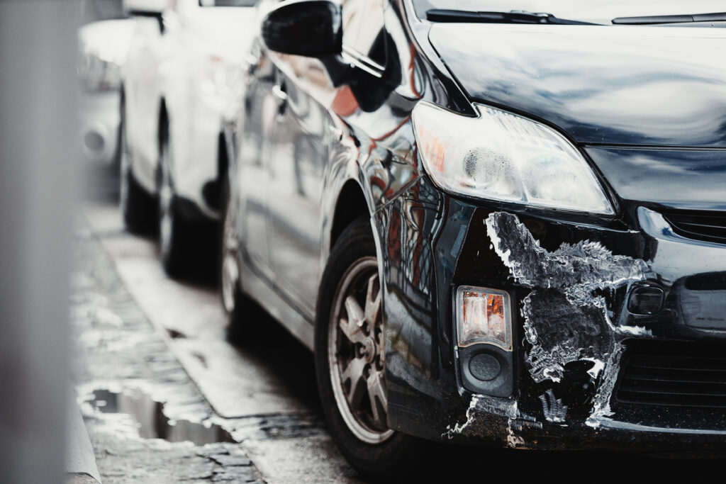 damaged car on city street after accident the la law firm uber accidents los angeles